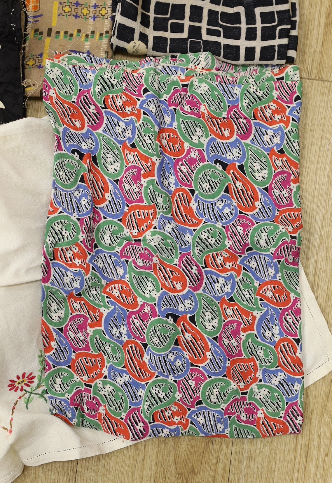 Various lengths of 1940's and later crepe, a large beaded edged cover and other fabrics, etc.
